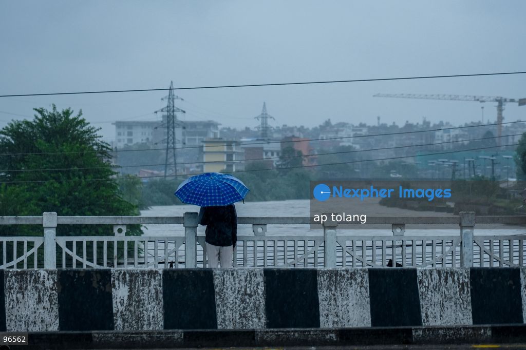 KATHMANDU, NEPAL —September 25, 2026: People walk along a street carrying umbrellas amid heavy rainfall in Lalitpur, Nepal. The rainfall has disrupted daily activities as a deep depression over the Bay of Bengal continues to influence weather conditions in the region. (Photo by ap tolang/Nexpher Images)