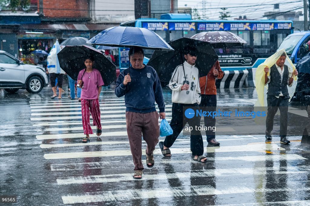 KATHMANDU, NEPAL —September 25, 2026: People walk along a street carrying umbrellas amid heavy rainfall in Lalitpur, Nepal. The rainfall has disrupted daily activities as a deep depression over the Bay of Bengal continues to influence weather conditions in the region. (Photo by ap tolang/Nexpher Images)
