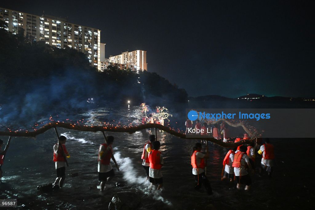 Performers putting a Fire Dragon into the sea during a fire dragon dance performance in Wah Fu Estate at Mid-autumn Festival on September 25, 2026 in Hong Kong. (Photo by Kobe Li/Nexpher Images)