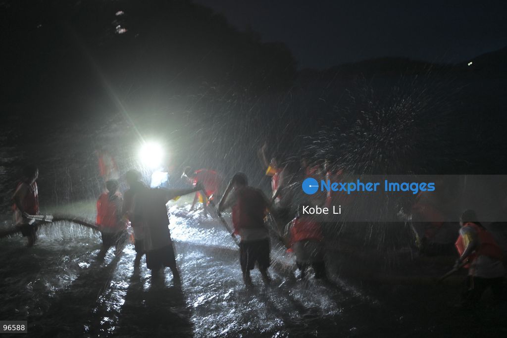 Performers putting a Fire Dragon into the sea during a fire dragon dance performance in Wah Fu Estate at Mid-autumn Festival on September 25, 2026 in Hong Kong. (Photo by Kobe Li/Nexpher Images)