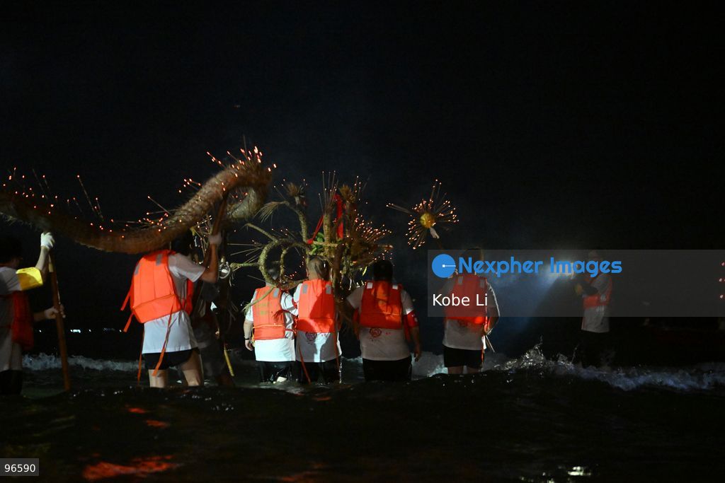 Performers putting a Fire Dragon into the sea during a fire dragon dance performance in Wah Fu Estate at Mid-autumn Festival on September 25, 2026 in Hong Kong. (Photo by Kobe Li/Nexpher Images)