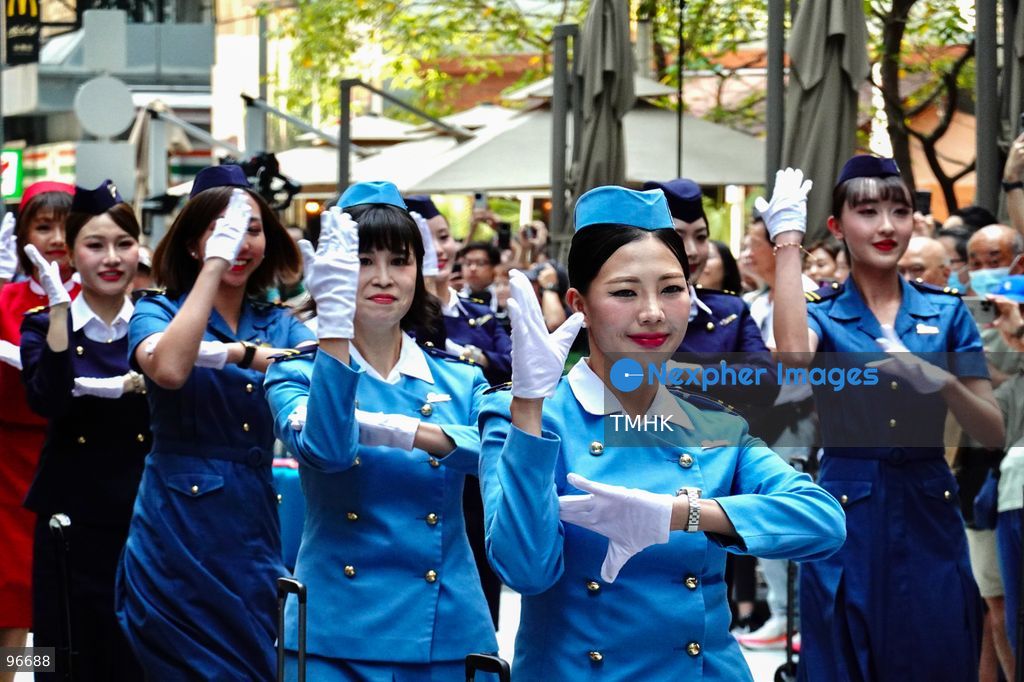 A general view shows cabin crew and ground staff wearing vintage and current uniforms performing alongside professional dancers during Cathay Pacific's 80th anniversary dance performance at Taikoo Place in Quarry Bay on September 24, 2026 in Hong Kong. Choreographed by the Hong Kong Dance Company, the flash mob-style showcase celebrated the airline's eight decades of journey alongside the city. (Photo by Zulu Lo/TMHK via Nexpher Images)