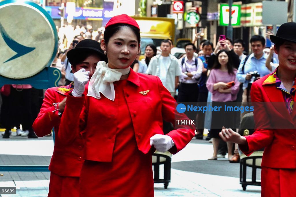 A general view shows cabin crew and ground staff wearing vintage and current uniforms performing alongside professional dancers during Cathay Pacific's 80th anniversary dance performance at Taikoo Place in Quarry Bay on September 24, 2026 in Hong Kong. Choreographed by the Hong Kong Dance Company, the flash mob-style showcase celebrated the airline's eight decades of journey alongside the city. (Photo by Zulu Lo/TMHK via Nexpher Images)