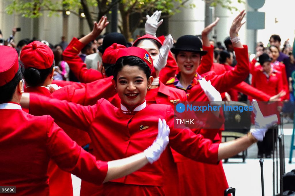 A general view shows cabin crew and ground staff wearing vintage and current uniforms performing alongside professional dancers during Cathay Pacific's 80th anniversary dance performance at Taikoo Place in Quarry Bay on September 24, 2026 in Hong Kong. Choreographed by the Hong Kong Dance Company, the flash mob-style showcase celebrated the airline's eight decades of journey alongside the city. (Photo by Zulu Lo/TMHK via Nexpher Images)