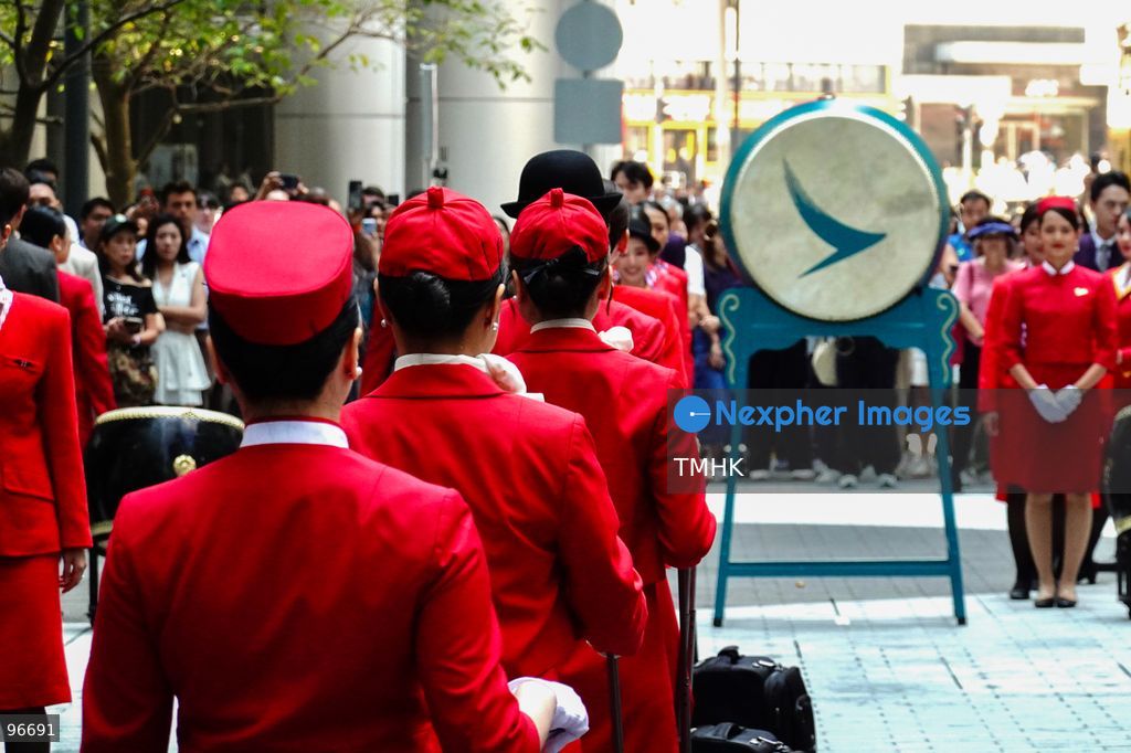 A general view shows cabin crew and ground staff wearing vintage and current uniforms performing alongside professional dancers during Cathay Pacific's 80th anniversary dance performance at Taikoo Place in Quarry Bay on September 24, 2026 in Hong Kong. Choreographed by the Hong Kong Dance Company, the flash mob-style showcase celebrated the airline's eight decades of journey alongside the city. (Photo by Zulu Lo/TMHK via Nexpher Images)