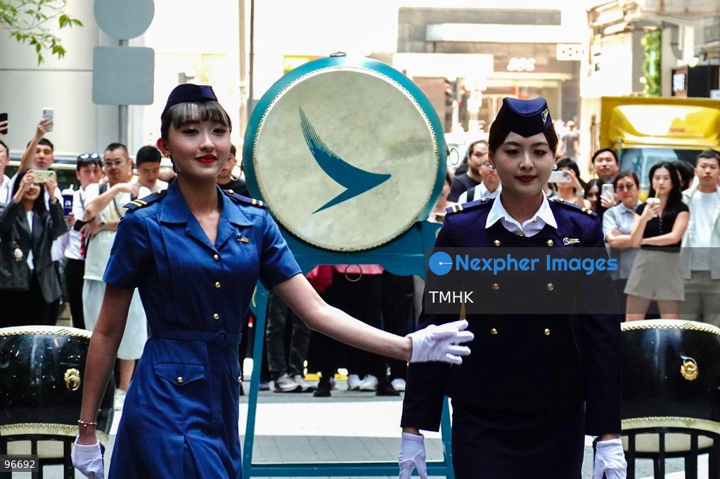 A general view shows cabin crew and ground staff wearing vintage and current uniforms performing alongside professional dancers during Cathay Pacific's 80th anniversary dance performance at Taikoo Place in Quarry Bay on September 24, 2026 in Hong Kong. Choreographed by the Hong Kong Dance Company, the flash mob-style showcase celebrated the airline's eight decades of journey alongside the city. (Photo by Zulu Lo/TMHK via Nexpher Images)