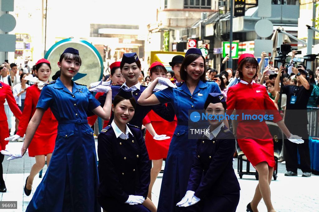 A general view shows cabin crew and ground staff wearing vintage and current uniforms performing alongside professional dancers during Cathay Pacific's 80th anniversary dance performance at Taikoo Place in Quarry Bay on September 24, 2026 in Hong Kong. Choreographed by the Hong Kong Dance Company, the flash mob-style showcase celebrated the airline's eight decades of journey alongside the city. (Photo by Zulu Lo/TMHK via Nexpher Images)