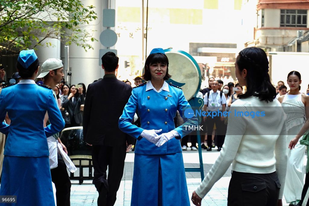 A general view shows cabin crew and ground staff wearing vintage and current uniforms performing alongside professional dancers during Cathay Pacific's 80th anniversary dance performance at Taikoo Place in Quarry Bay on September 24, 2026 in Hong Kong. Choreographed by the Hong Kong Dance Company, the flash mob-style showcase celebrated the airline's eight decades of journey alongside the city. (Photo by Zulu Lo/TMHK via Nexpher Images)