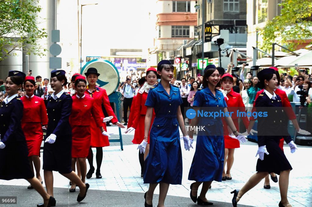 A general view shows cabin crew and ground staff wearing vintage and current uniforms performing alongside professional dancers during Cathay Pacific's 80th anniversary dance performance at Taikoo Place in Quarry Bay on September 24, 2026 in Hong Kong. Choreographed by the Hong Kong Dance Company, the flash mob-style showcase celebrated the airline's eight decades of journey alongside the city. (Photo by Zulu Lo/TMHK via Nexpher Images)