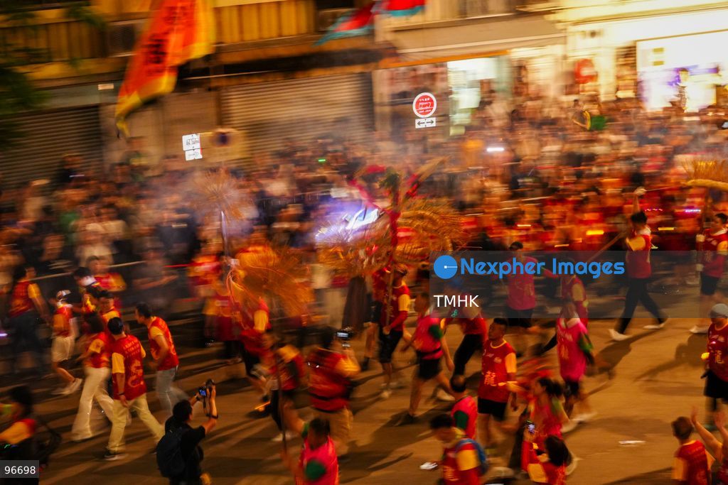 The incense-laden fire dragon weaves through public corridors and plazas of Wah Fu Estate on September 25, 2026 in Hong Kong, surrounded by dense crowds of neighbourhood residents cheering from walkways and balconies ahead of the estate's planned redevelopment. (Photo by Zulu Lo/TMHK via Nexpher Images)