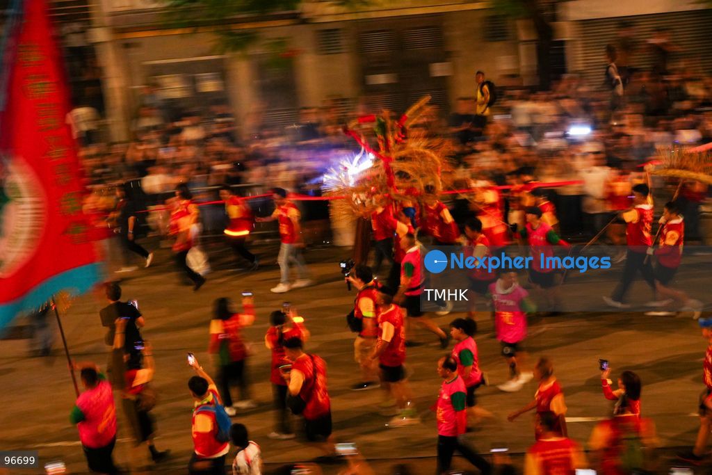 The incense-laden fire dragon weaves through public corridors and plazas of Wah Fu Estate on September 25, 2026 in Hong Kong, surrounded by dense crowds of neighbourhood residents cheering from walkways and balconies ahead of the estate's planned redevelopment. (Photo by Zulu Lo/TMHK via Nexpher Images)