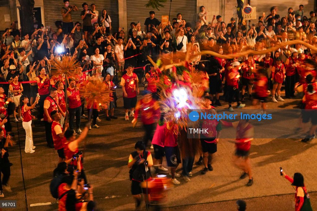 The incense-laden fire dragon weaves through public corridors and plazas of Wah Fu Estate on September 25, 2026 in Hong Kong, surrounded by dense crowds of neighbourhood residents cheering from walkways and balconies ahead of the estate's planned redevelopment. (Photo by Zulu Lo/TMHK via Nexpher Images)