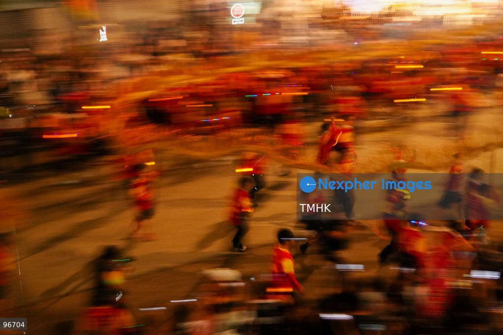 The incense-laden fire dragon weaves through public corridors and plazas of Wah Fu Estate on September 25, 2026 in Hong Kong, surrounded by dense crowds of neighbourhood residents cheering from walkways and balconies ahead of the estate's planned redevelopment. (Photo by Zulu Lo/TMHK via Nexpher Images)