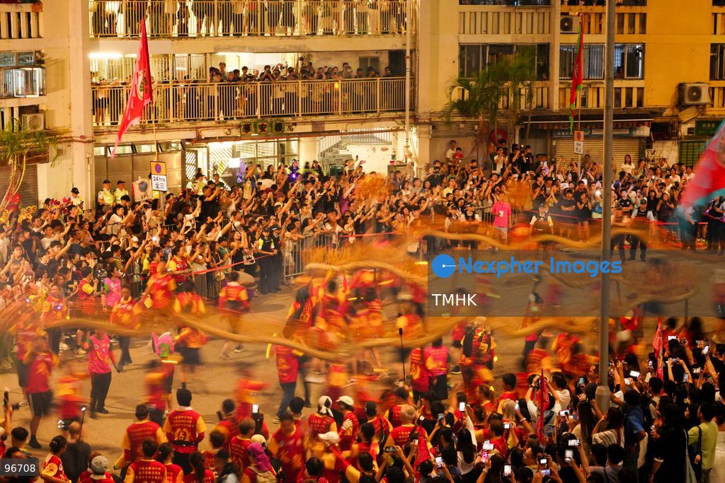 The incense-laden fire dragon weaves through public corridors and plazas of Wah Fu Estate on September 25, 2026 in Hong Kong, surrounded by dense crowds of neighbourhood residents cheering from walkways and balconies ahead of the estate's planned redevelopment. (Photo by Zulu Lo/TMHK via Nexpher Images)