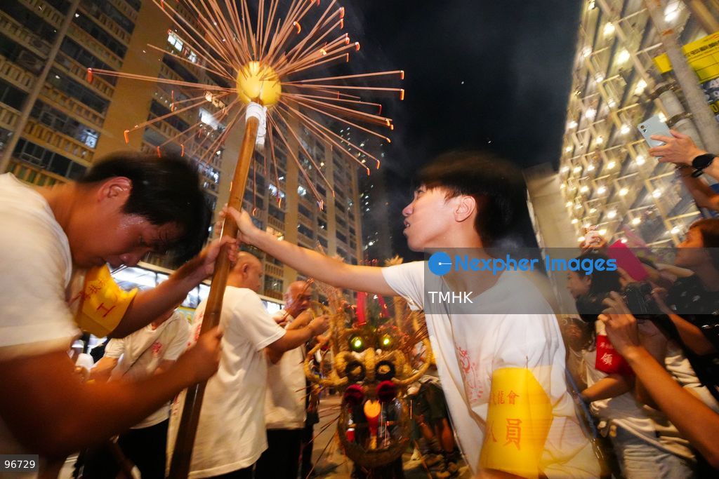 The incense-laden fire dragon weaves through public corridors and plazas of Wah Fu Estate on September 25, 2026 in Hong Kong, surrounded by dense crowds of neighbourhood residents cheering from walkways and balconies ahead of the estate's planned redevelopment. (Photo by Zulu Lo/TMHK via Nexpher Images)