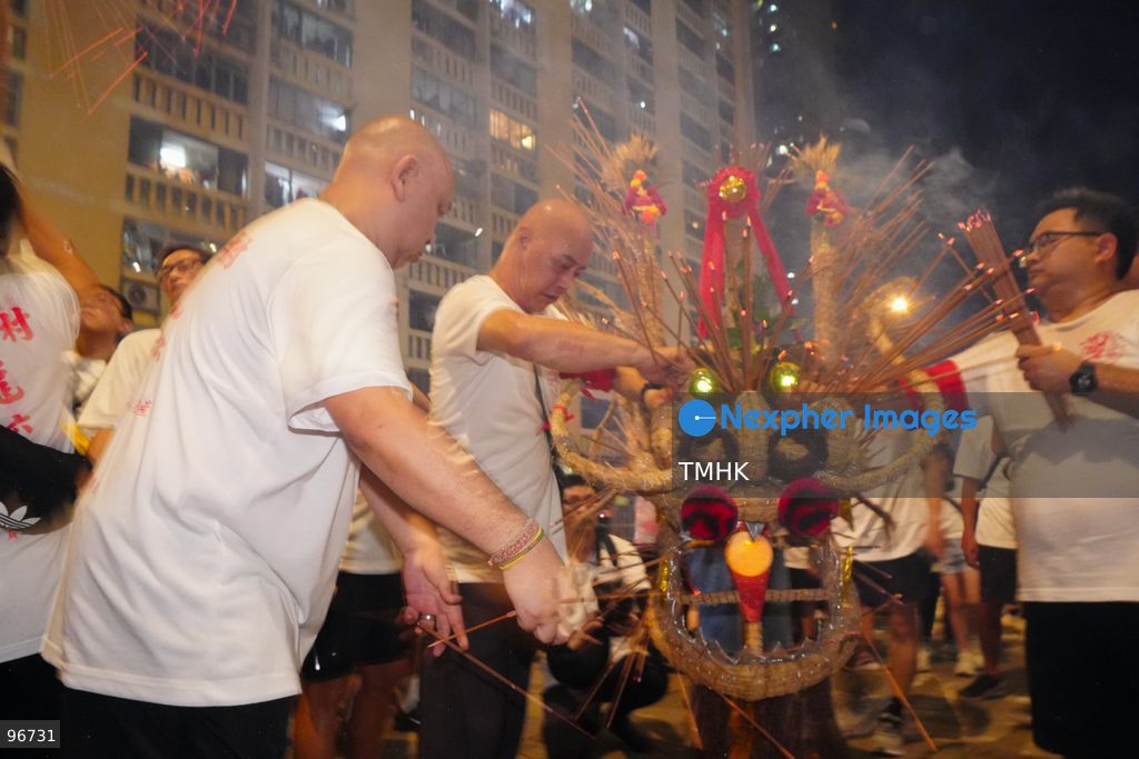 The incense-laden fire dragon weaves through public corridors and plazas of Wah Fu Estate on September 25, 2026 in Hong Kong, surrounded by dense crowds of neighbourhood residents cheering from walkways and balconies ahead of the estate's planned redevelopment. (Photo by Zulu Lo/TMHK via Nexpher Images)