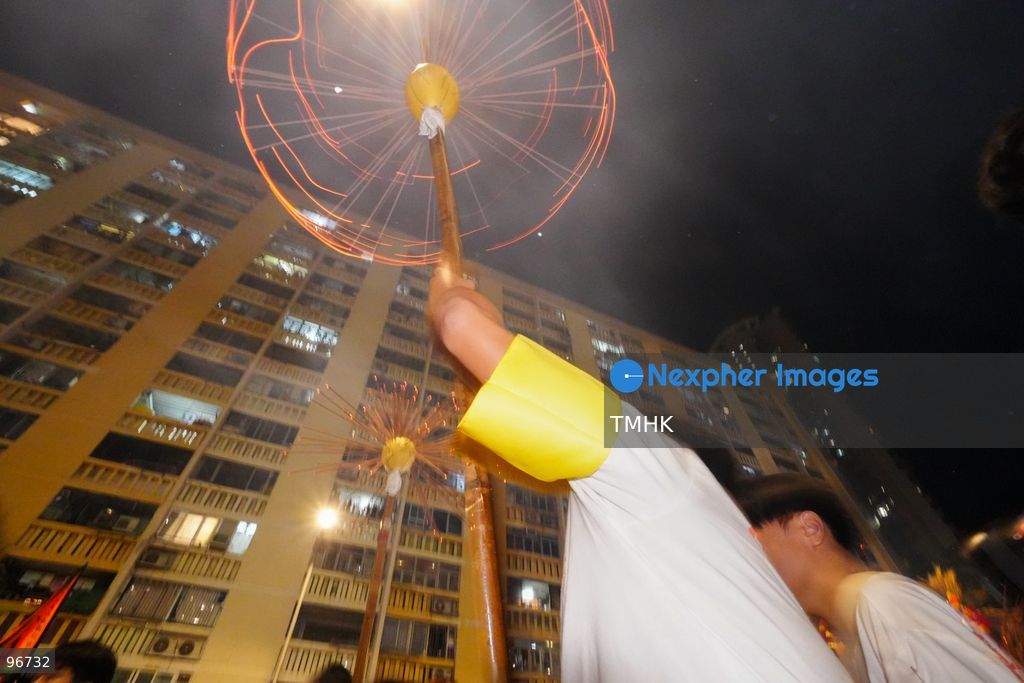 The incense-laden fire dragon weaves through public corridors and plazas of Wah Fu Estate on September 25, 2026 in Hong Kong, surrounded by dense crowds of neighbourhood residents cheering from walkways and balconies ahead of the estate's planned redevelopment. (Photo by Zulu Lo/TMHK via Nexpher Images)