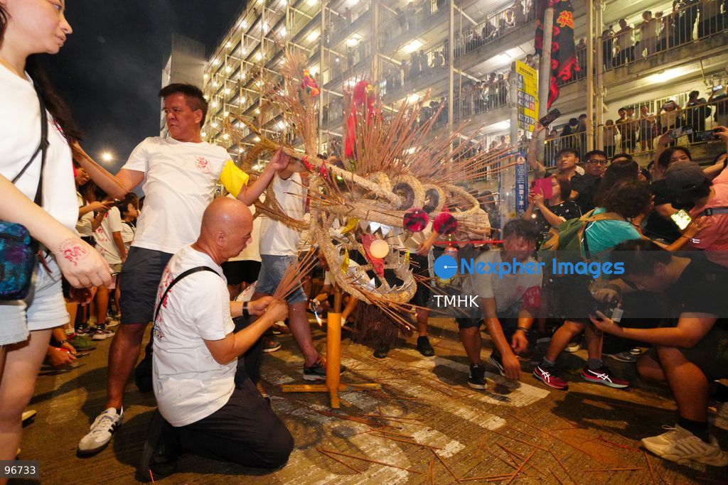 The incense-laden fire dragon weaves through public corridors and plazas of Wah Fu Estate on September 25, 2026 in Hong Kong, surrounded by dense crowds of neighbourhood residents cheering from walkways and balconies ahead of the estate's planned redevelopment. (Photo by Zulu Lo/TMHK via Nexpher Images)