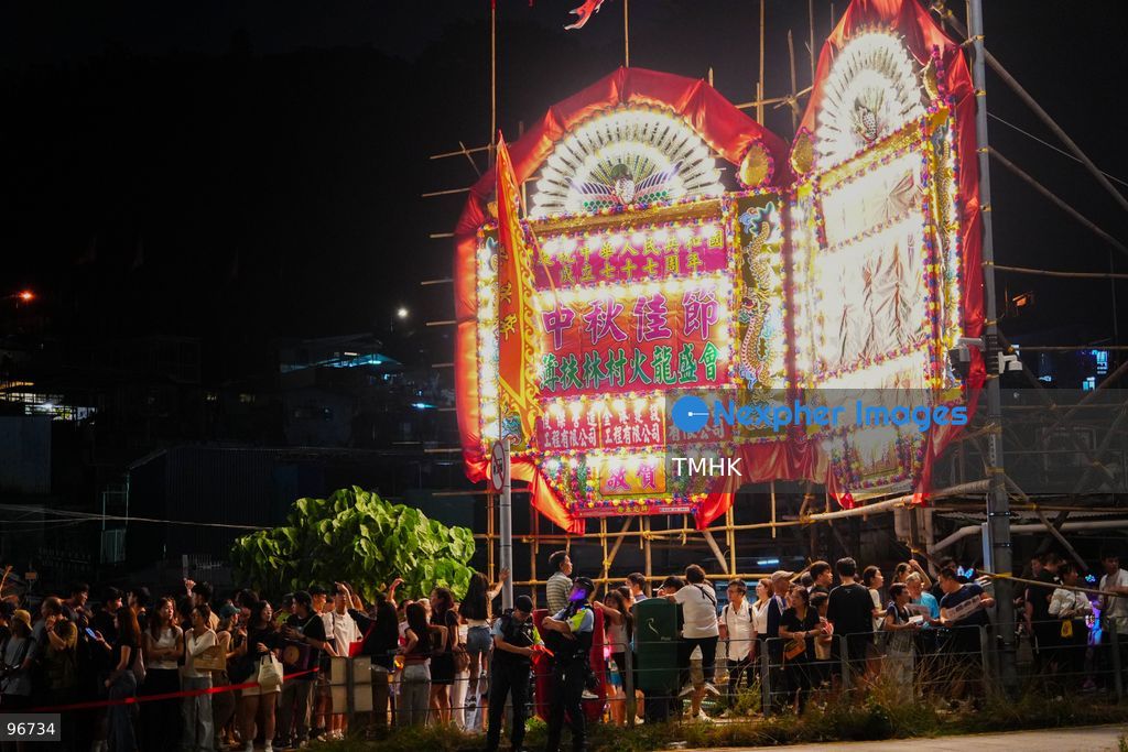 Villagers parade the 30-metre-long fire dragon, glowing with thousands of burning incense sticks, through the narrow alleys of Pok Fu Lam Village on September 25, 2026 in Hong Kong. The century-old Mid-Autumn Festival tradition kicks off with blessings inside the historical indigenous settlement before making its journey across the Southern District. (Photo by Zulu Lo/TMHK via Nexpher Images)