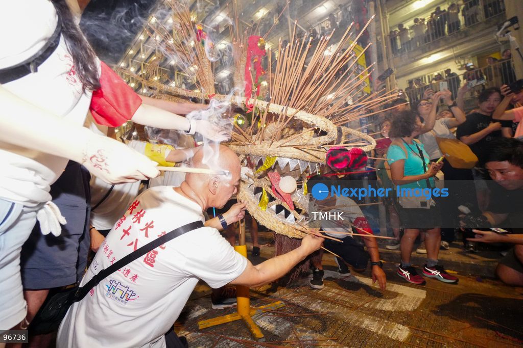 The incense-laden fire dragon weaves through public corridors and plazas of Wah Fu Estate on September 25, 2026 in Hong Kong, surrounded by dense crowds of neighbourhood residents cheering from walkways and balconies ahead of the estate's planned redevelopment. (Photo by Zulu Lo/TMHK via Nexpher Images)