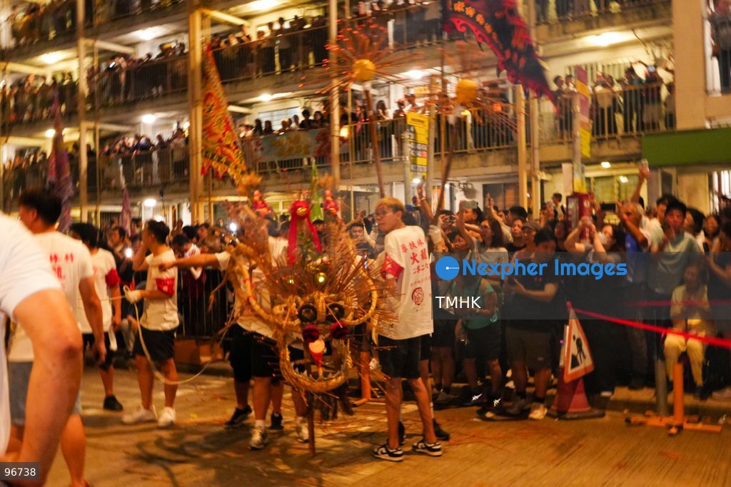 The incense-laden fire dragon weaves through public corridors and plazas of Wah Fu Estate on September 25, 2026 in Hong Kong, surrounded by dense crowds of neighbourhood residents cheering from walkways and balconies ahead of the estate's planned redevelopment. (Photo by Zulu Lo/TMHK via Nexpher Images)