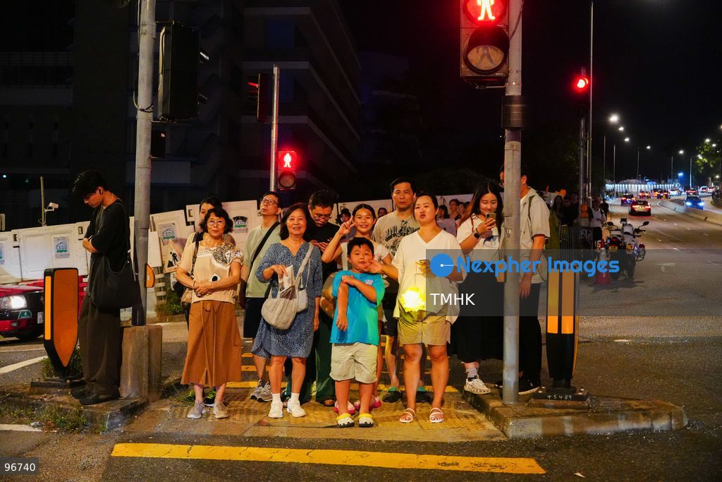 Villagers parade the 30-metre-long fire dragon, glowing with thousands of burning incense sticks, through the narrow alleys of Pok Fu Lam Village on September 25, 2026 in Hong Kong. The century-old Mid-Autumn Festival tradition kicks off with blessings inside the historical indigenous settlement before making its journey across the Southern District. (Photo by Zulu Lo/TMHK via Nexpher Images)