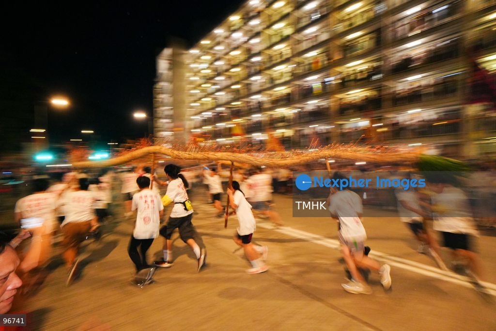 The incense-laden fire dragon weaves through public corridors and plazas of Wah Fu Estate on September 25, 2026 in Hong Kong, surrounded by dense crowds of neighbourhood residents cheering from walkways and balconies ahead of the estate's planned redevelopment. (Photo by Zulu Lo/TMHK via Nexpher Images)