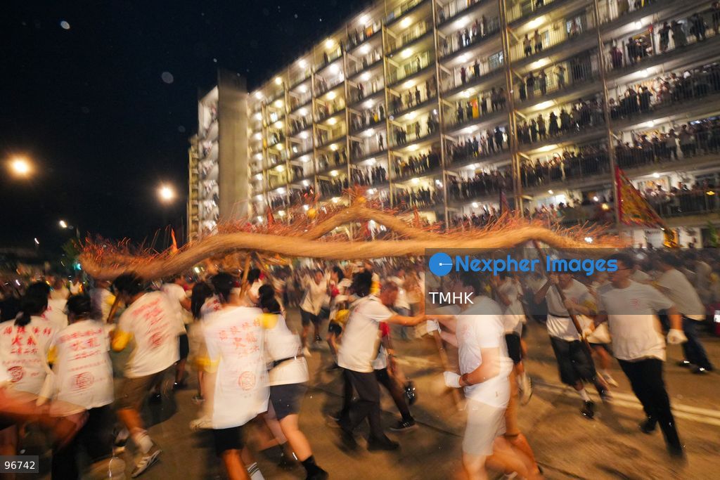 The incense-laden fire dragon weaves through public corridors and plazas of Wah Fu Estate on September 25, 2026 in Hong Kong, surrounded by dense crowds of neighbourhood residents cheering from walkways and balconies ahead of the estate's planned redevelopment. (Photo by Zulu Lo/TMHK via Nexpher Images)