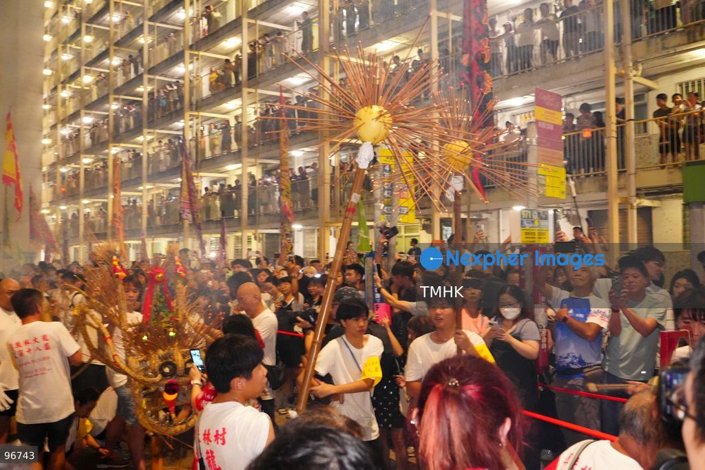 The incense-laden fire dragon weaves through public corridors and plazas of Wah Fu Estate on September 25, 2026 in Hong Kong, surrounded by dense crowds of neighbourhood residents cheering from walkways and balconies ahead of the estate's planned redevelopment. (Photo by Zulu Lo/TMHK via Nexpher Images)