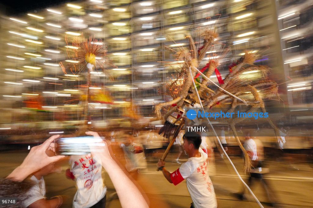 The incense-laden fire dragon weaves through public corridors and plazas of Wah Fu Estate on September 25, 2026 in Hong Kong, surrounded by dense crowds of neighbourhood residents cheering from walkways and balconies ahead of the estate's planned redevelopment. (Photo by Zulu Lo/TMHK via Nexpher Images)