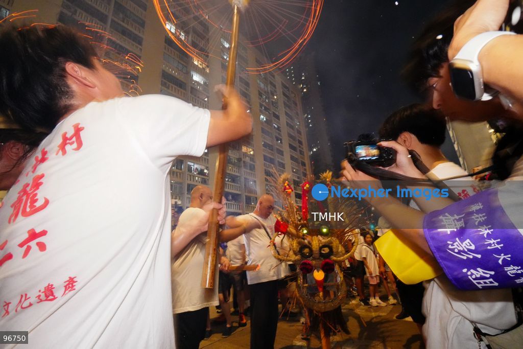 The incense-laden fire dragon weaves through public corridors and plazas of Wah Fu Estate on September 25, 2026 in Hong Kong, surrounded by dense crowds of neighbourhood residents cheering from walkways and balconies ahead of the estate's planned redevelopment. (Photo by Zulu Lo/TMHK via Nexpher Images)