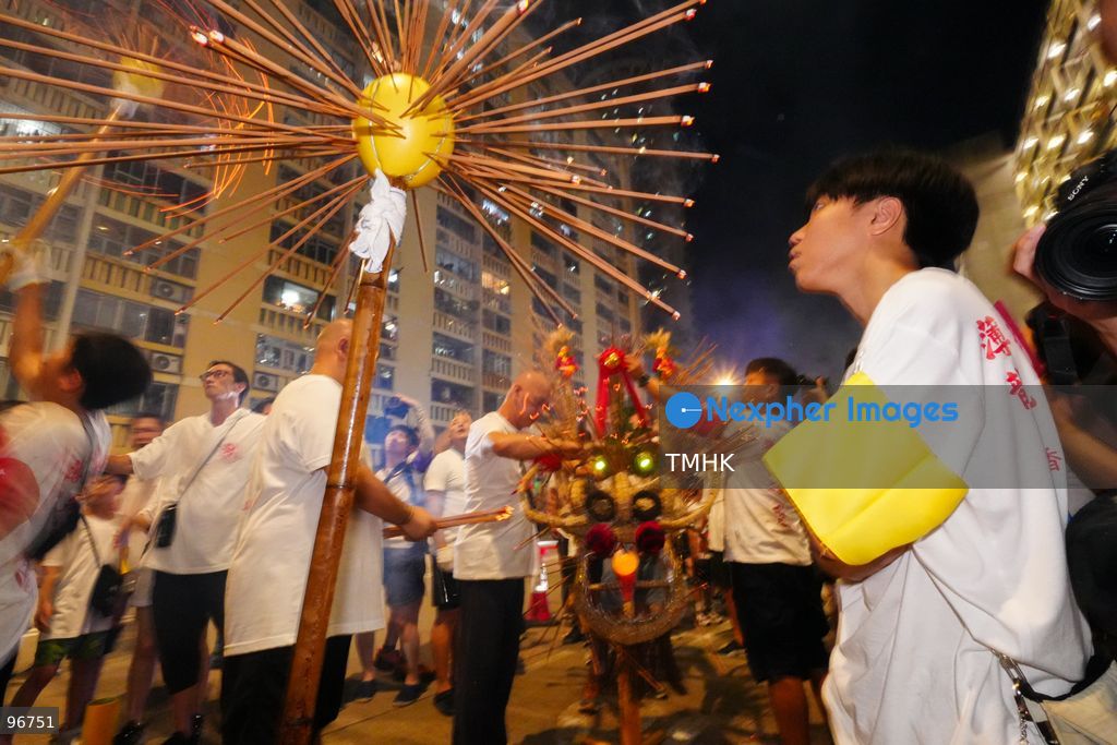 The incense-laden fire dragon weaves through public corridors and plazas of Wah Fu Estate on September 25, 2026 in Hong Kong, surrounded by dense crowds of neighbourhood residents cheering from walkways and balconies ahead of the estate's planned redevelopment. (Photo by Zulu Lo/TMHK via Nexpher Images)