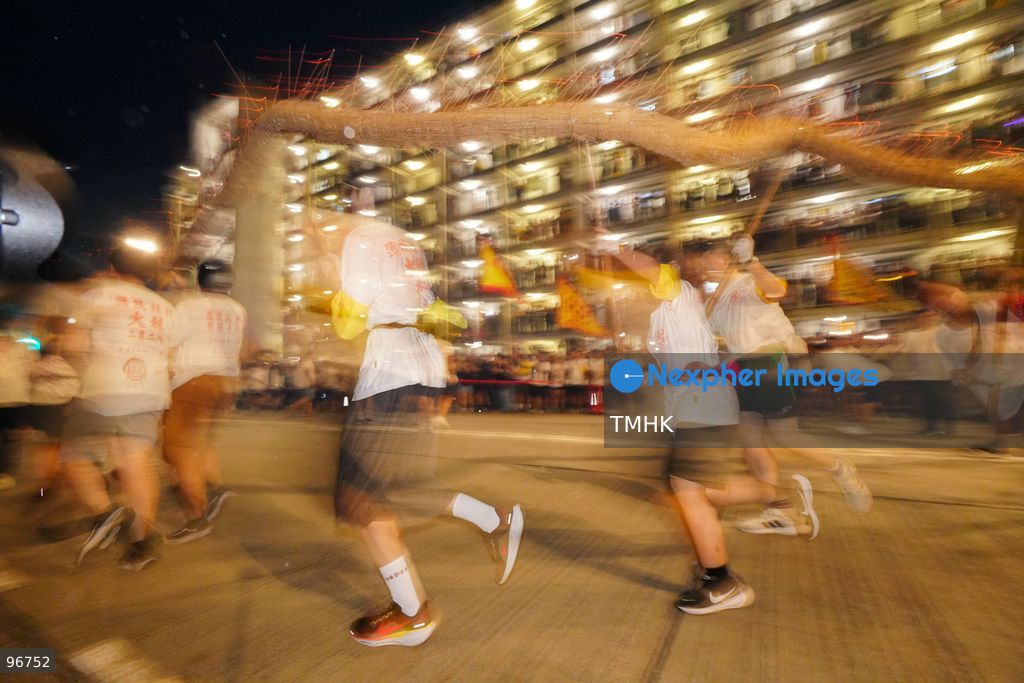 The incense-laden fire dragon weaves through public corridors and plazas of Wah Fu Estate on September 25, 2026 in Hong Kong, surrounded by dense crowds of neighbourhood residents cheering from walkways and balconies ahead of the estate's planned redevelopment. (Photo by Zulu Lo/TMHK via Nexpher Images)