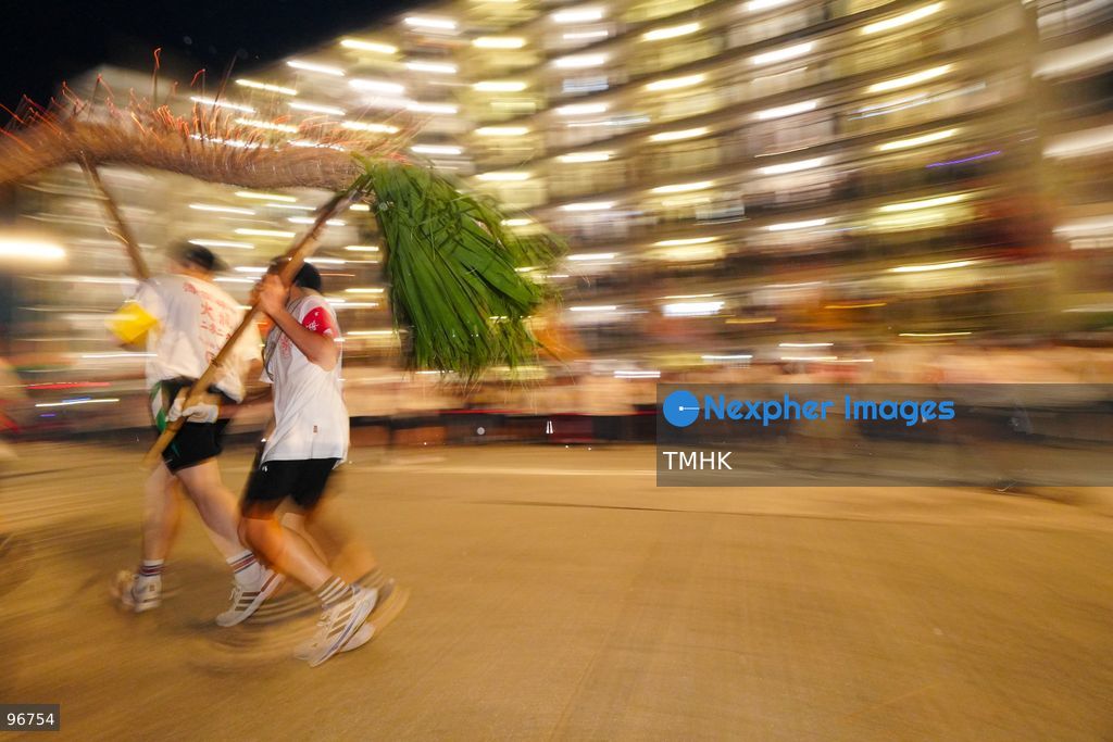 The incense-laden fire dragon weaves through public corridors and plazas of Wah Fu Estate on September 25, 2026 in Hong Kong, surrounded by dense crowds of neighbourhood residents cheering from walkways and balconies ahead of the estate's planned redevelopment. (Photo by Zulu Lo/TMHK via Nexpher Images)