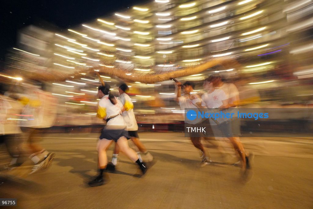 The incense-laden fire dragon weaves through public corridors and plazas of Wah Fu Estate on September 25, 2026 in Hong Kong, surrounded by dense crowds of neighbourhood residents cheering from walkways and balconies ahead of the estate's planned redevelopment. (Photo by Zulu Lo/TMHK via Nexpher Images)