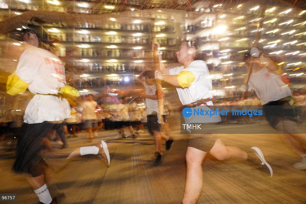 The incense-laden fire dragon weaves through public corridors and plazas of Wah Fu Estate on September 25, 2026 in Hong Kong, surrounded by dense crowds of neighbourhood residents cheering from walkways and balconies ahead of the estate's planned redevelopment. (Photo by Zulu Lo/TMHK via Nexpher Images)