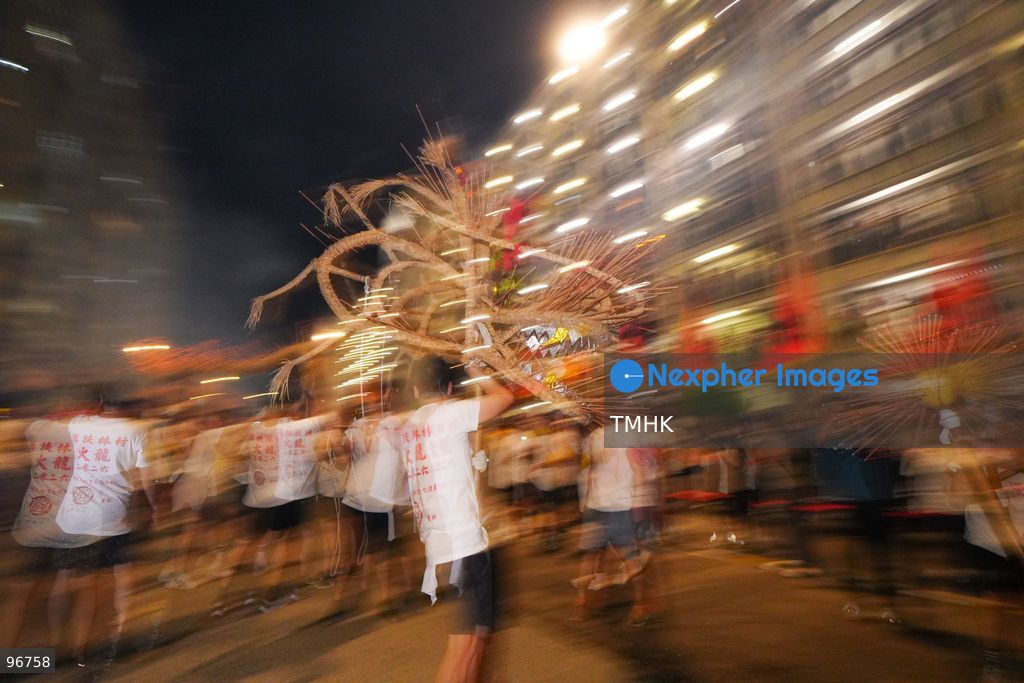 The incense-laden fire dragon weaves through public corridors and plazas of Wah Fu Estate on September 25, 2026 in Hong Kong, surrounded by dense crowds of neighbourhood residents cheering from walkways and balconies ahead of the estate's planned redevelopment. (Photo by Zulu Lo/TMHK via Nexpher Images)