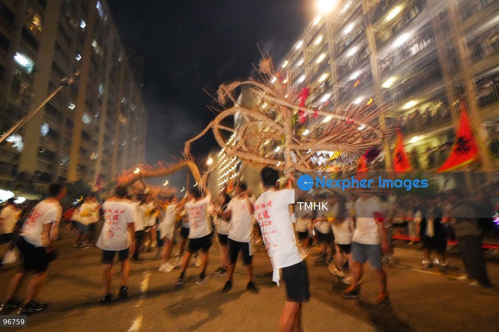 The incense-laden fire dragon weaves through public corridors and plazas of Wah Fu Estate on September 25, 2026 in Hong Kong, surrounded by dense crowds of neighbourhood residents cheering from walkways and balconies ahead of the estate's planned redevelopment. (Photo by Zulu Lo/TMHK via Nexpher Images)