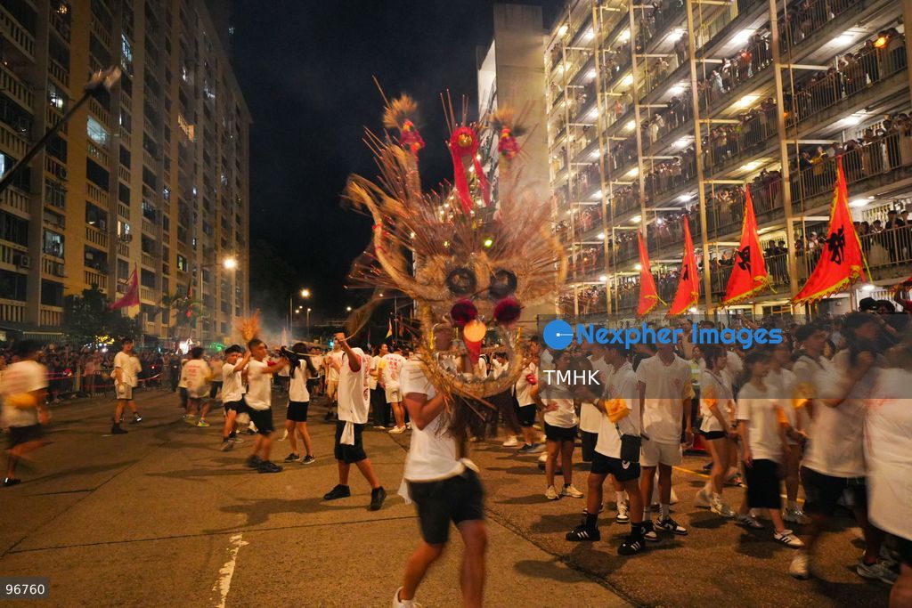 The incense-laden fire dragon weaves through public corridors and plazas of Wah Fu Estate on September 25, 2026 in Hong Kong, surrounded by dense crowds of neighbourhood residents cheering from walkways and balconies ahead of the estate's planned redevelopment. (Photo by Zulu Lo/TMHK via Nexpher Images)