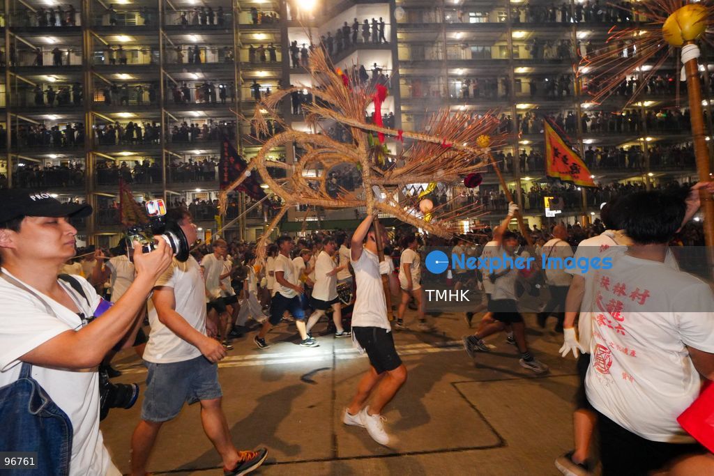 The incense-laden fire dragon weaves through public corridors and plazas of Wah Fu Estate on September 25, 2026 in Hong Kong, surrounded by dense crowds of neighbourhood residents cheering from walkways and balconies ahead of the estate's planned redevelopment. (Photo by Zulu Lo/TMHK via Nexpher Images)