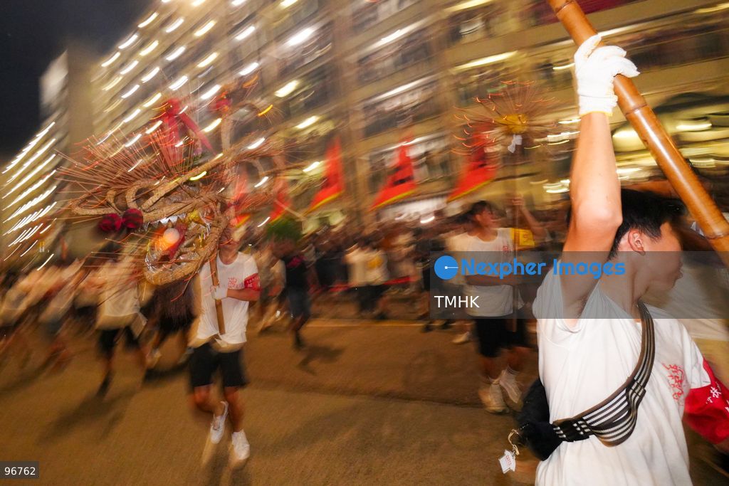 The incense-laden fire dragon weaves through public corridors and plazas of Wah Fu Estate on September 25, 2026 in Hong Kong, surrounded by dense crowds of neighbourhood residents cheering from walkways and balconies ahead of the estate's planned redevelopment. (Photo by Zulu Lo/TMHK via Nexpher Images)
