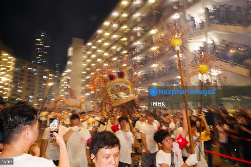 The incense-laden fire dragon weaves through public corridors and plazas of Wah Fu Estate on September 25, 2026 in Hong Kong, surrounded by dense crowds of neighbourhood residents cheering from walkways and balconies ahead of the estate's planned redevelopment. (Photo by Zulu Lo/TMHK via Nexpher Images)