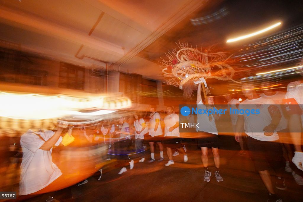 The incense-laden fire dragon weaves through public corridors and plazas of Wah Fu Estate on September 25, 2026 in Hong Kong, surrounded by dense crowds of neighbourhood residents cheering from walkways and balconies ahead of the estate's planned redevelopment. (Photo by Zulu Lo/TMHK via Nexpher Images)