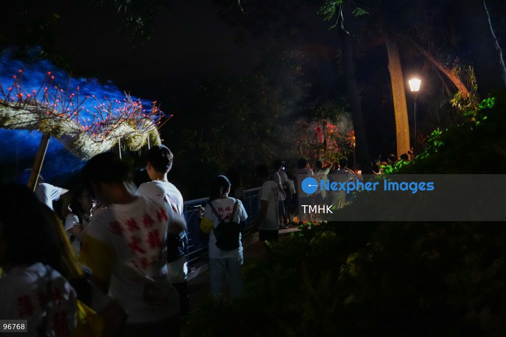 Villagers and performers wade into the waters off Waterfall Bay Park to submerge the 30-metre fire dragon in the sea on September 25, 2026 in Hong Kong, marking the sacred "Dragon Returning to the Sea" ritual as glowing incense sticks extinguish in the surf, signifying the successful completion of the Mid-Autumn blessings. (Photo by Zulu Lo/TMHK via Nexpher Images)