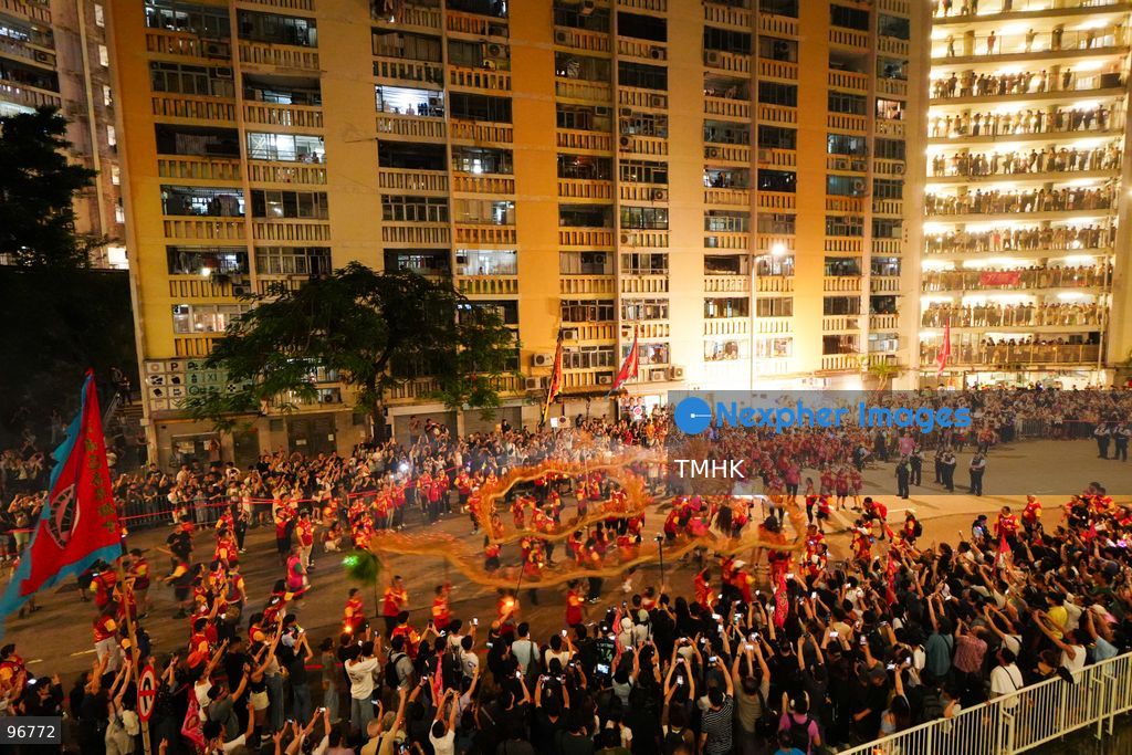The incense-laden fire dragon weaves through public corridors and plazas of Wah Fu Estate on September 25, 2026 in Hong Kong, surrounded by dense crowds of neighbourhood residents cheering from walkways and balconies ahead of the estate's planned redevelopment. (Photo by Zulu Lo/TMHK via Nexpher Images)