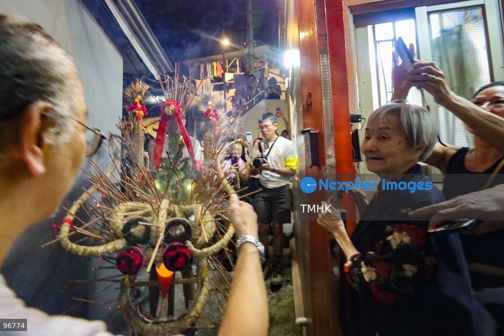 Villagers parade the 30-metre-long fire dragon, glowing with thousands of burning incense sticks, through the narrow alleys of Pok Fu Lam Village on September 25, 2026 in Hong Kong. The century-old Mid-Autumn Festival tradition kicks off with blessings inside the historical indigenous settlement before making its journey across the Southern District. (Photo by Gordon Choi/TMHK via Nexpher Images)