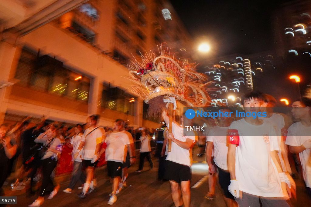 The incense-laden fire dragon weaves through public corridors and plazas of Wah Fu Estate on September 25, 2026 in Hong Kong, surrounded by dense crowds of neighbourhood residents cheering from walkways and balconies ahead of the estate's planned redevelopment. (Photo by Zulu Lo/TMHK via Nexpher Images)