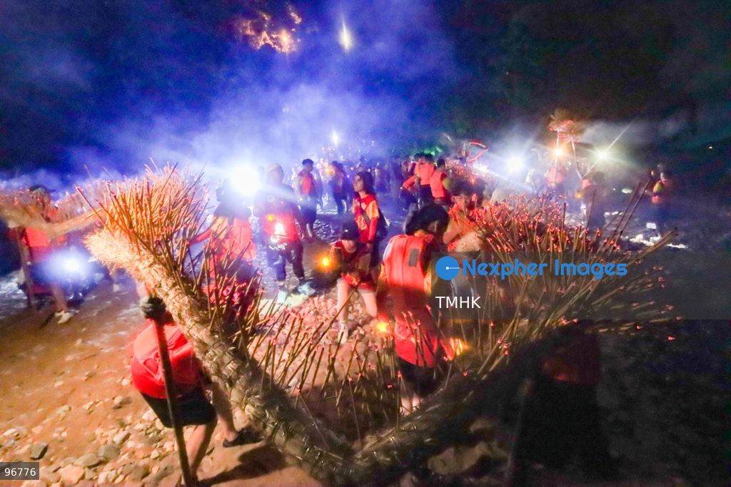 Villagers and performers wade into the waters off Waterfall Bay Park to submerge the 30-metre fire dragon in the sea on September 25, 2026 in Hong Kong, marking the sacred "Dragon Returning to the Sea" ritual as glowing incense sticks extinguish in the surf, signifying the successful completion of the Mid-Autumn blessings. (Photo by Gordon Choi/TMHK via Nexpher Images)