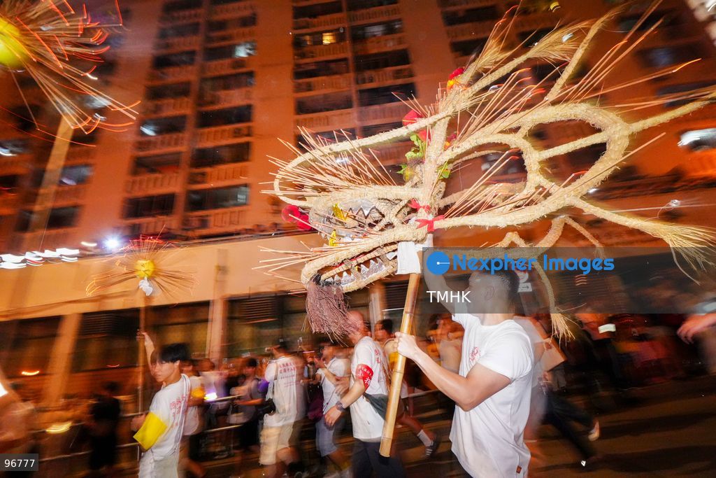 The incense-laden fire dragon weaves through public corridors and plazas of Wah Fu Estate on September 25, 2026 in Hong Kong, surrounded by dense crowds of neighbourhood residents cheering from walkways and balconies ahead of the estate's planned redevelopment. (Photo by Zulu Lo/TMHK via Nexpher Images)