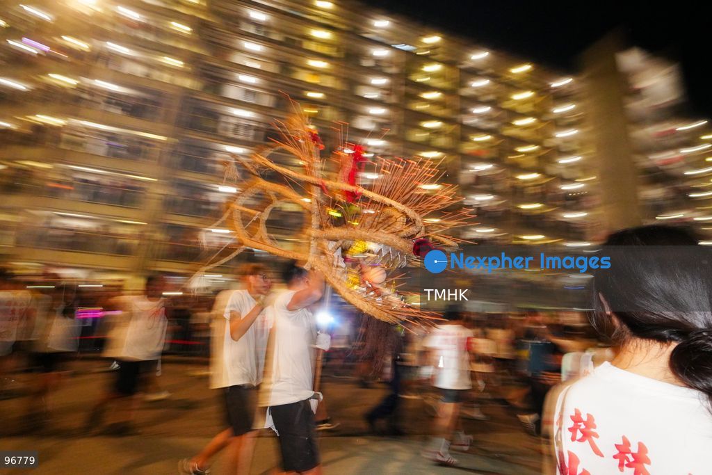 The incense-laden fire dragon weaves through public corridors and plazas of Wah Fu Estate on September 25, 2026 in Hong Kong, surrounded by dense crowds of neighbourhood residents cheering from walkways and balconies ahead of the estate's planned redevelopment. (Photo by Zulu Lo/TMHK via Nexpher Images)